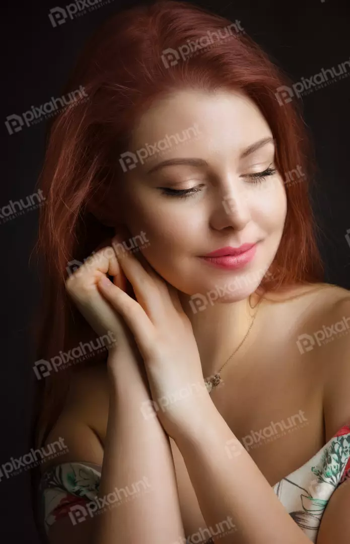 Beautiful Redhead Woman with Closed Eyes, Serene Expression and Gentle Hands