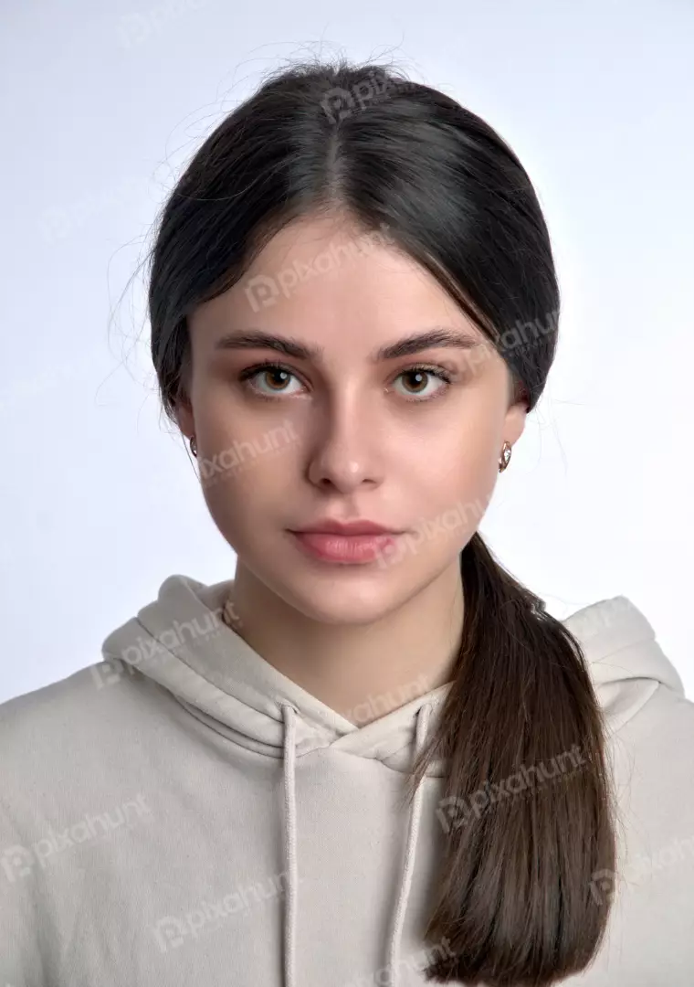 Confident Young Woman Looking Directly at Camera in Casual Hoodie Studio Shot