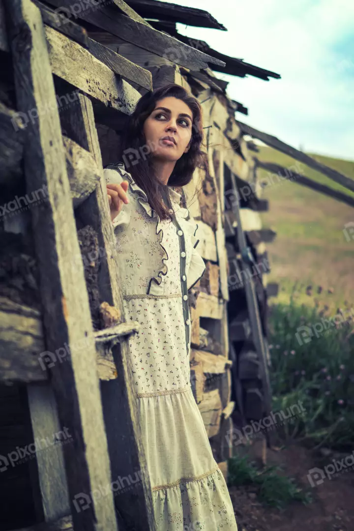 Free Premium Stock Photos Pensive Woman in Vintage Floral Dress by Weathered Wood Structure
