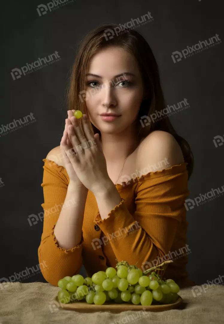 Young Woman Posing Delicately with Fresh Green Grapes