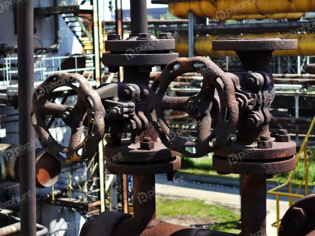 Detail of Old Rusty Industrial Valves and Pipes in Neglected Factory