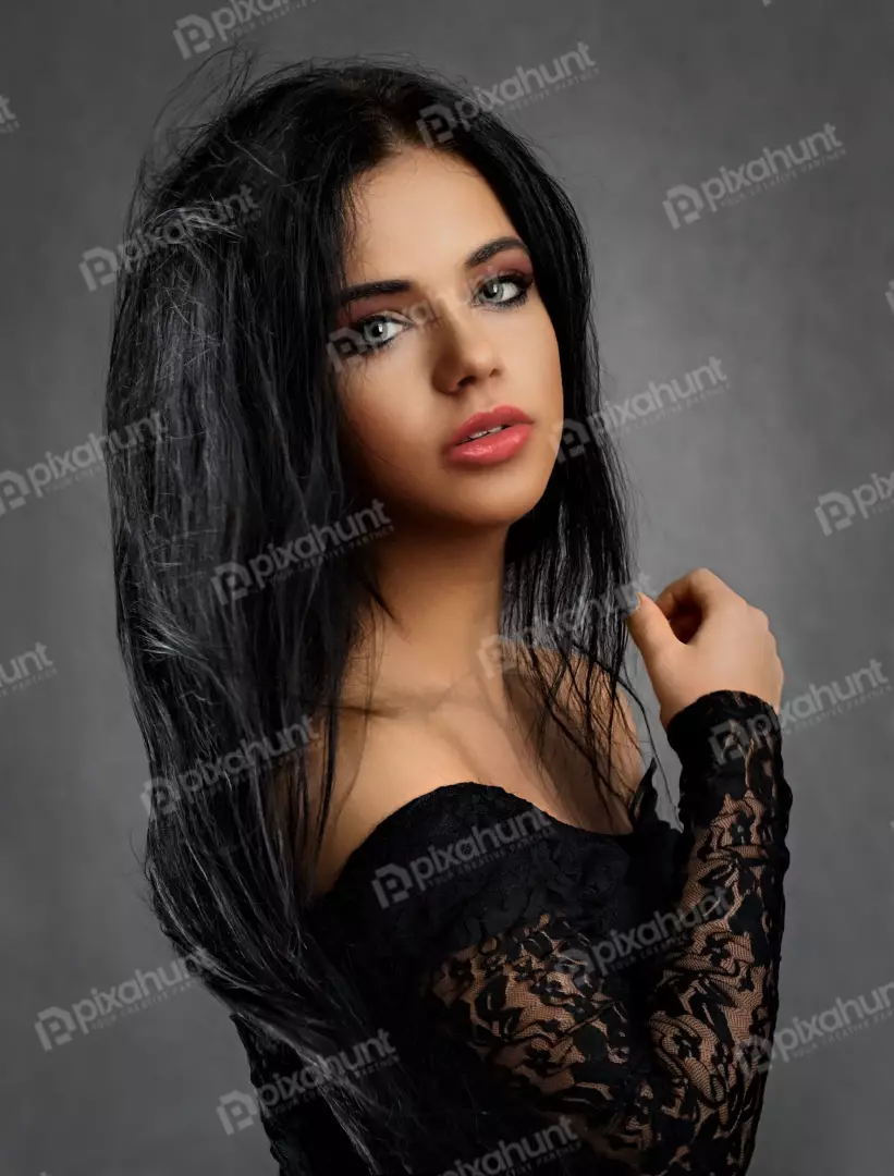 Captivating Young Woman in Black Lace Dress with Direct Gaze