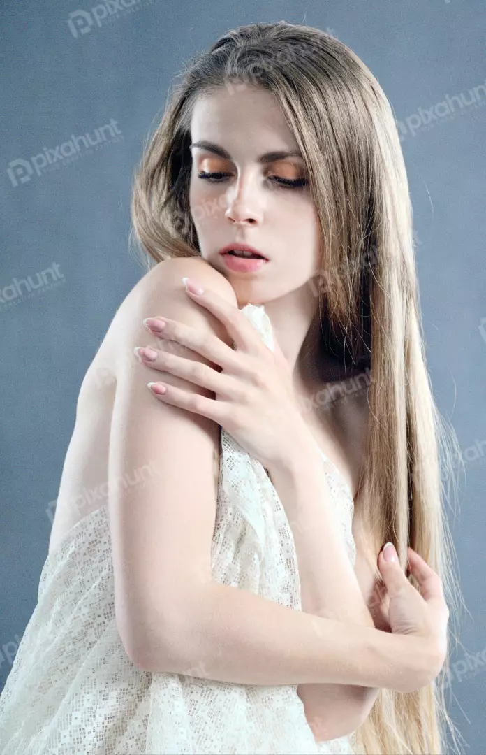 Ethereal Young Woman with Long Blonde Hair Draped in Sheer Lace and Soft Eyes
