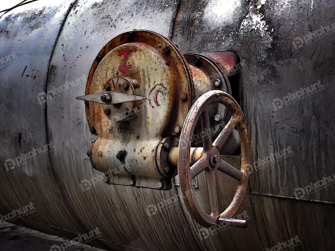 Close-up of Old Rusty Industrial Valve with Handwheel on Weathered Metal Pipe