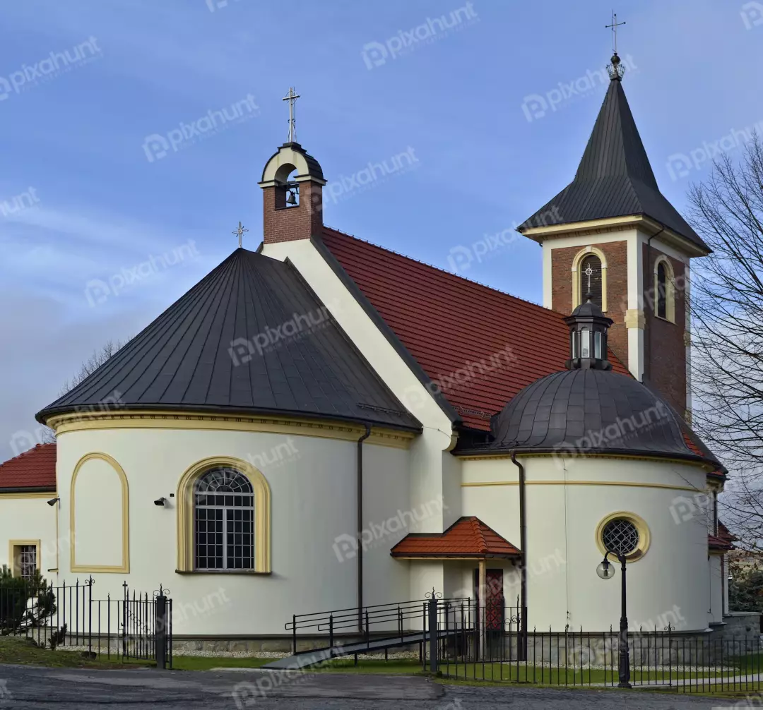 Classic European Church with Bell Tower, Dome, and Ornate Fence