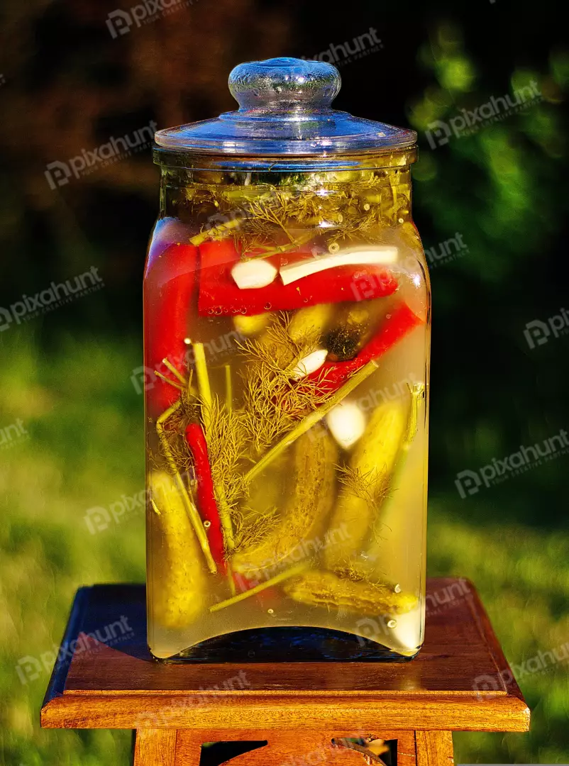 Homemade Pickled Cucumbers, Spicy Red Peppers, Garlic, and Dill in a Glass Jar