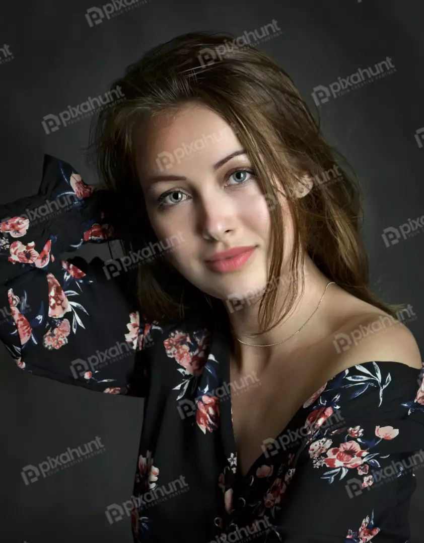Portrait of Young Woman in Floral Off-Shoulder Top with Green Eyes