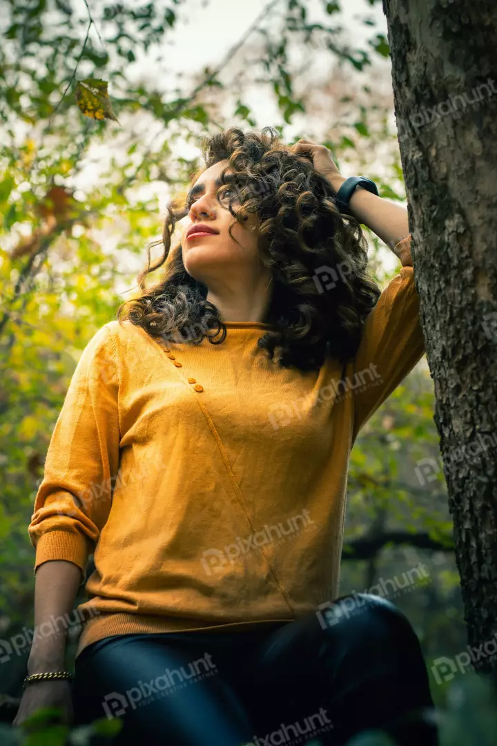 Free Premium Stock Photos Autumn Serenity Curly-Haired Woman in Yellow Outdoors