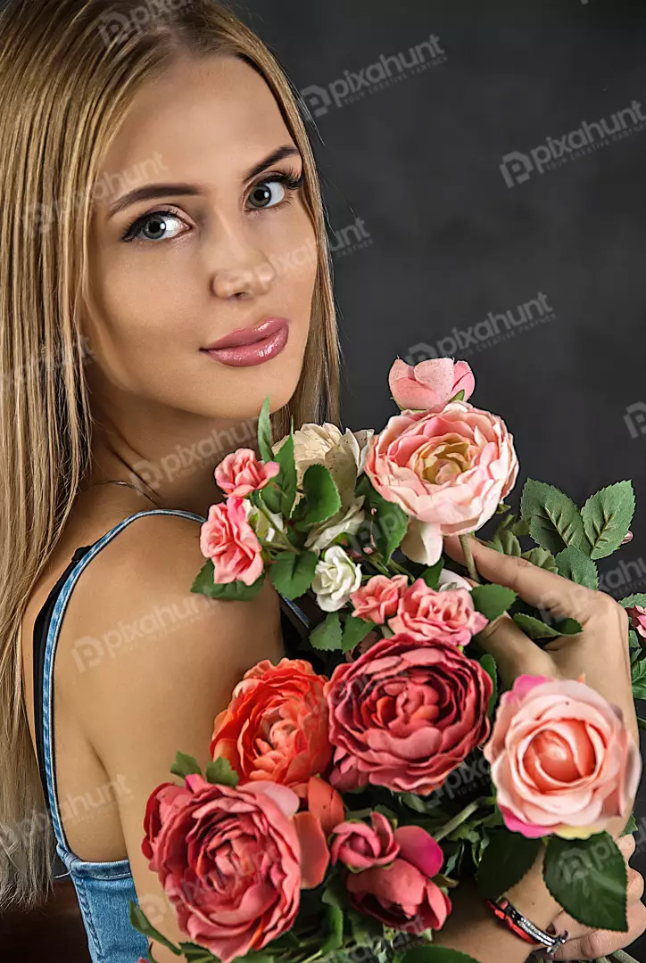 Blonde Woman Posing Elegantly with Vibrant Pink and Red Floral Bouquet
