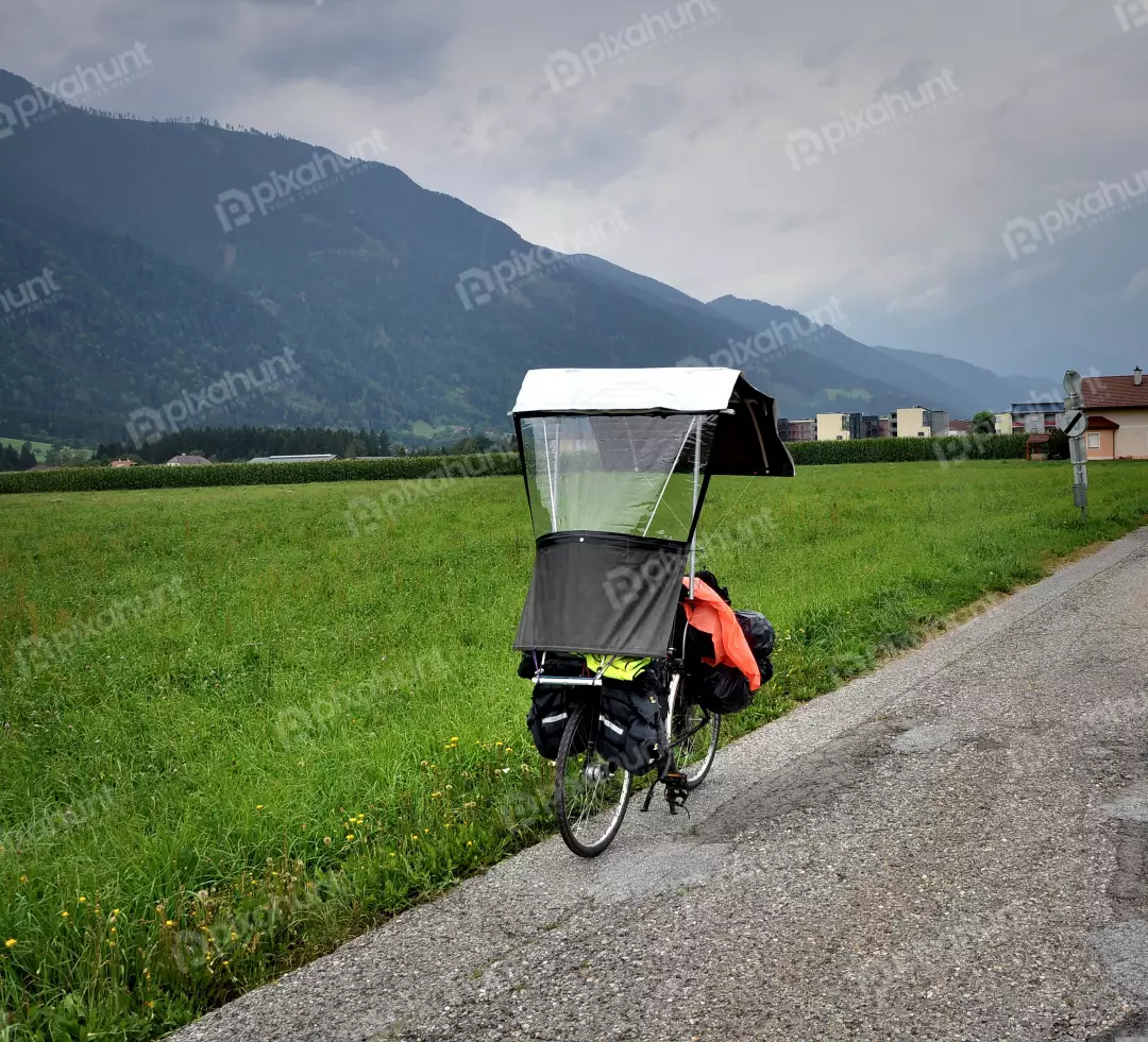 Touring Bicycle with Rain Canopy in Mountainous Green Landscape