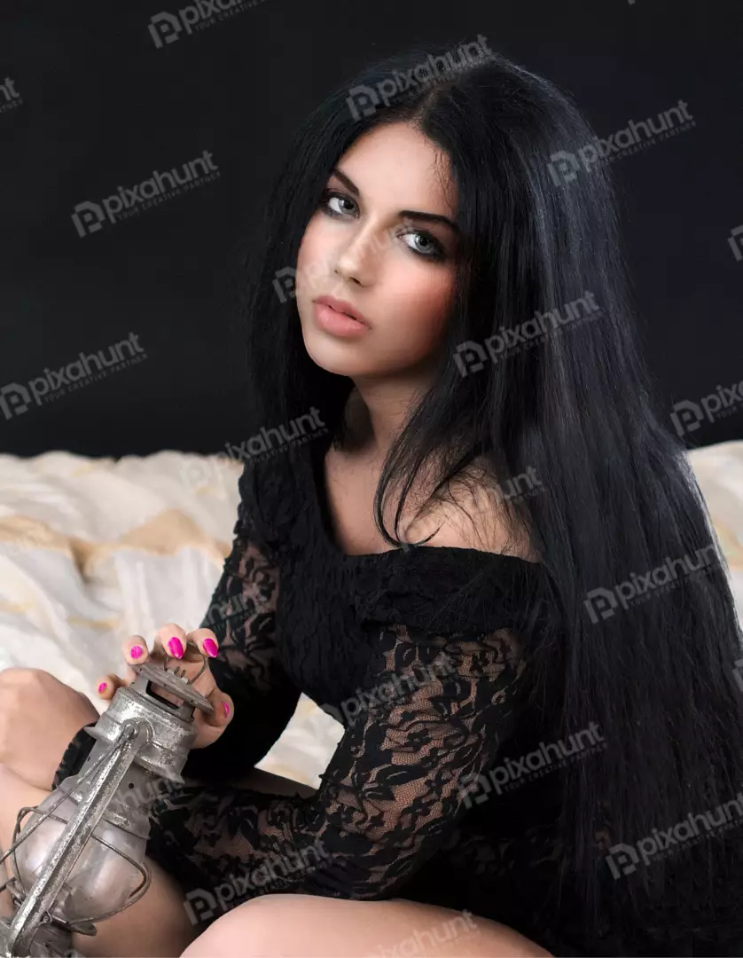 Mysterious Woman with Long Black Hair Holding Vintage Lantern