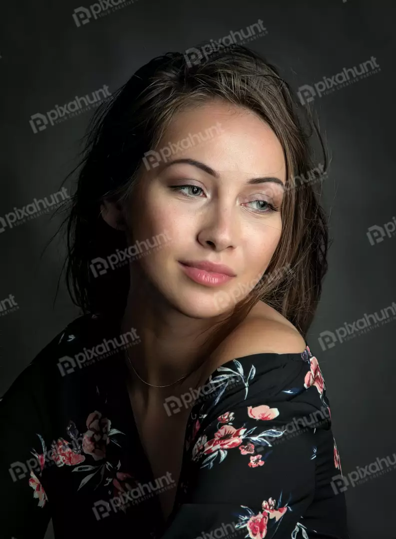 Elegant Young Woman in Floral Off-Shoulder Top Posing Thoughtfully