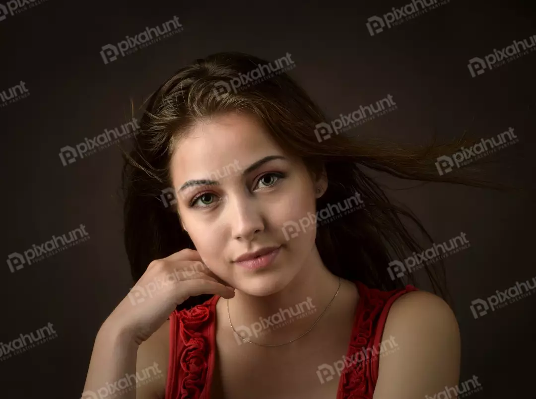 Serene Young Woman with Green Eyes and Windswept Hair Portrait
