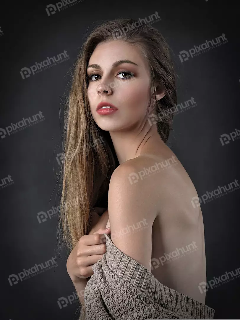Captivating Young Woman in Knit Sweater with Intense Gaze