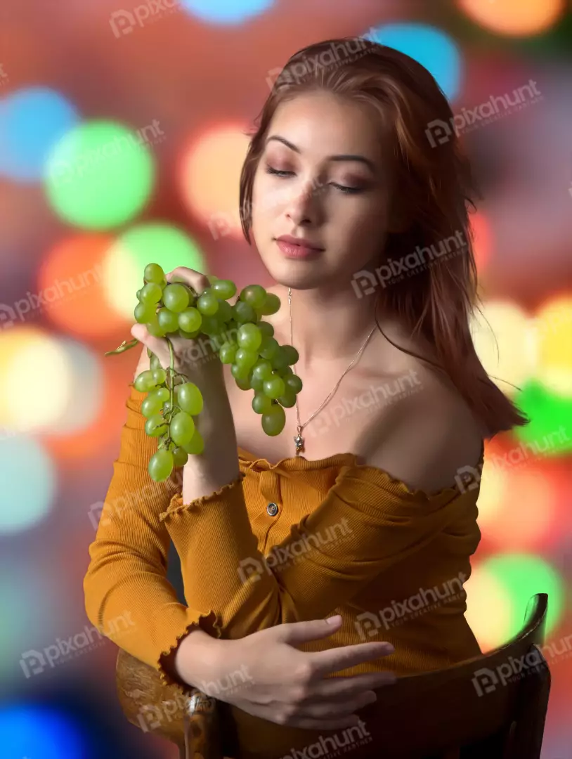 Young Woman Savoring Fresh Green Grapes Amidst Vibrant Bokeh Lights