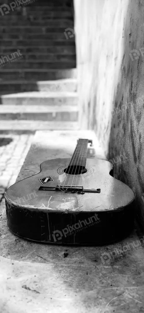 Free Premium Stock Photos Vintage Acoustic Guitar Leaning Against Textured Wall with Stairs Background
