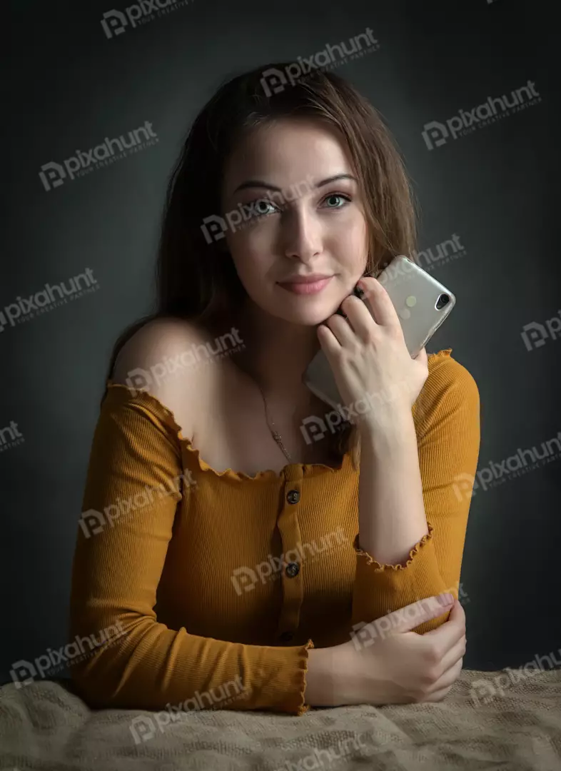 Fashionable Woman with Smartphone, Yellow Ribbed Top and Subtle Smile