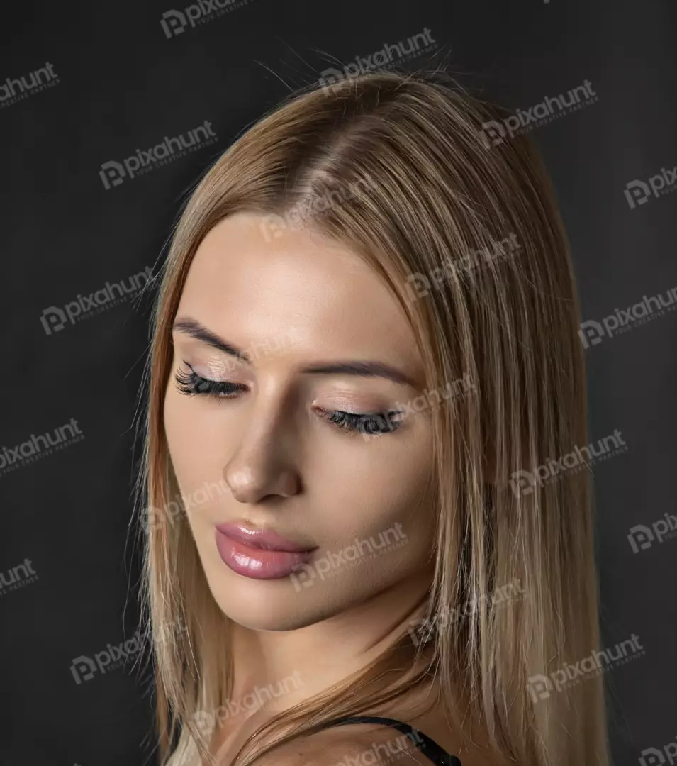 Serene Blonde Woman Portrait with Closed Eyes, Elegant Makeup, and Glossy Lips
