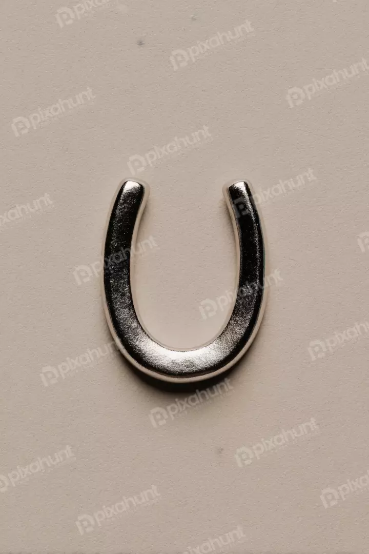 Free Premium Stock Photos Elegant Silver Horseshoe for Good Fortune Against a Soft Textured Backdrop
