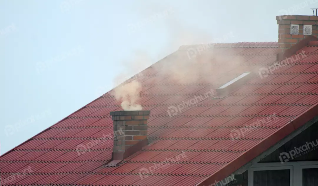 Red Tiled Roof with Smoking Brick Chimney and Skylight