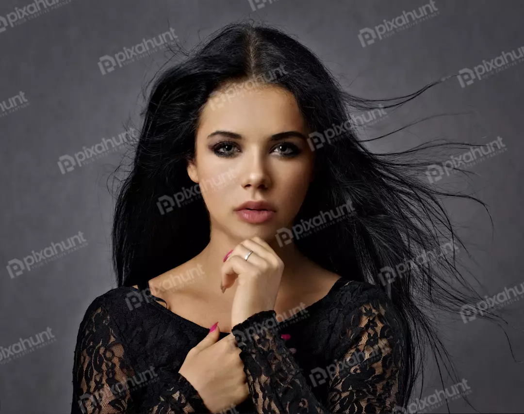 Captivating Woman with Flowing Dark Hair Posing in Black Lace Top