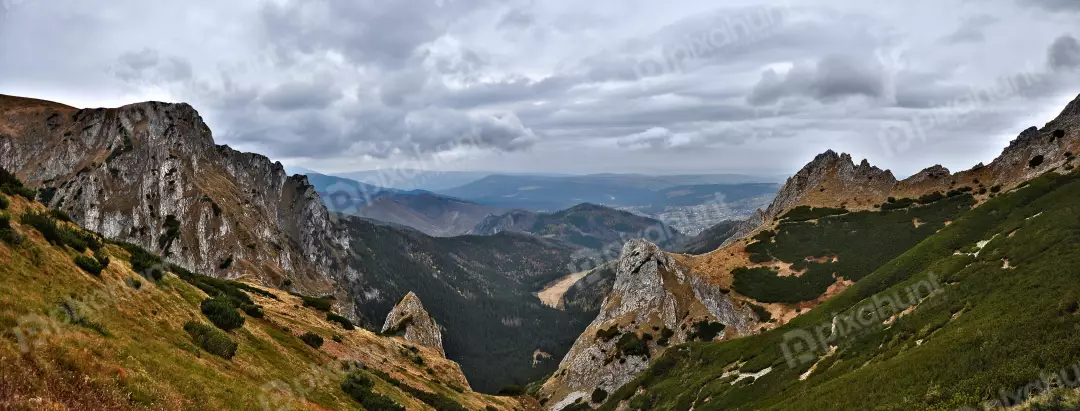 Panoramic Mountain Valley View Under Overcast Sky