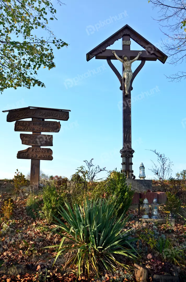Rustic Wooden Crucifix with Jesus Figure, Polish Roadside Sign, Autumnal Rural Scene