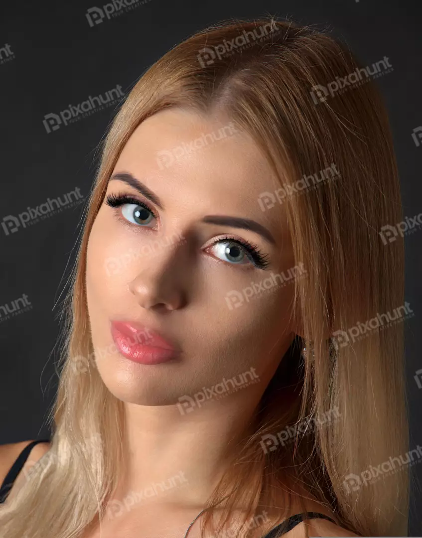 Blonde Woman with Intense Blue Eyes and Pink Lips Gazing at Camera