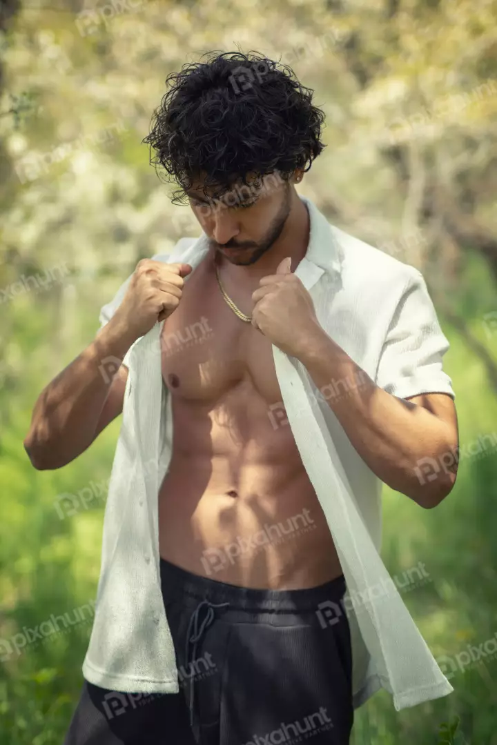 Free Premium Stock Photos Toned Man in Open White Shirt Amidst Green Foliage