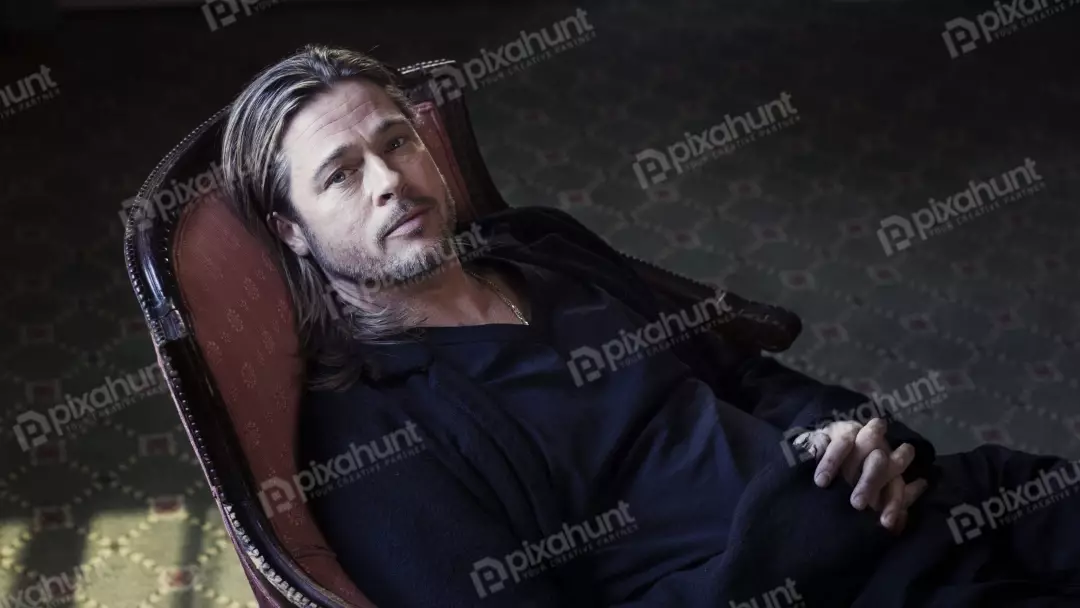 Brad Pitt Lounging in Ornate Chair with Contemplative Gaze