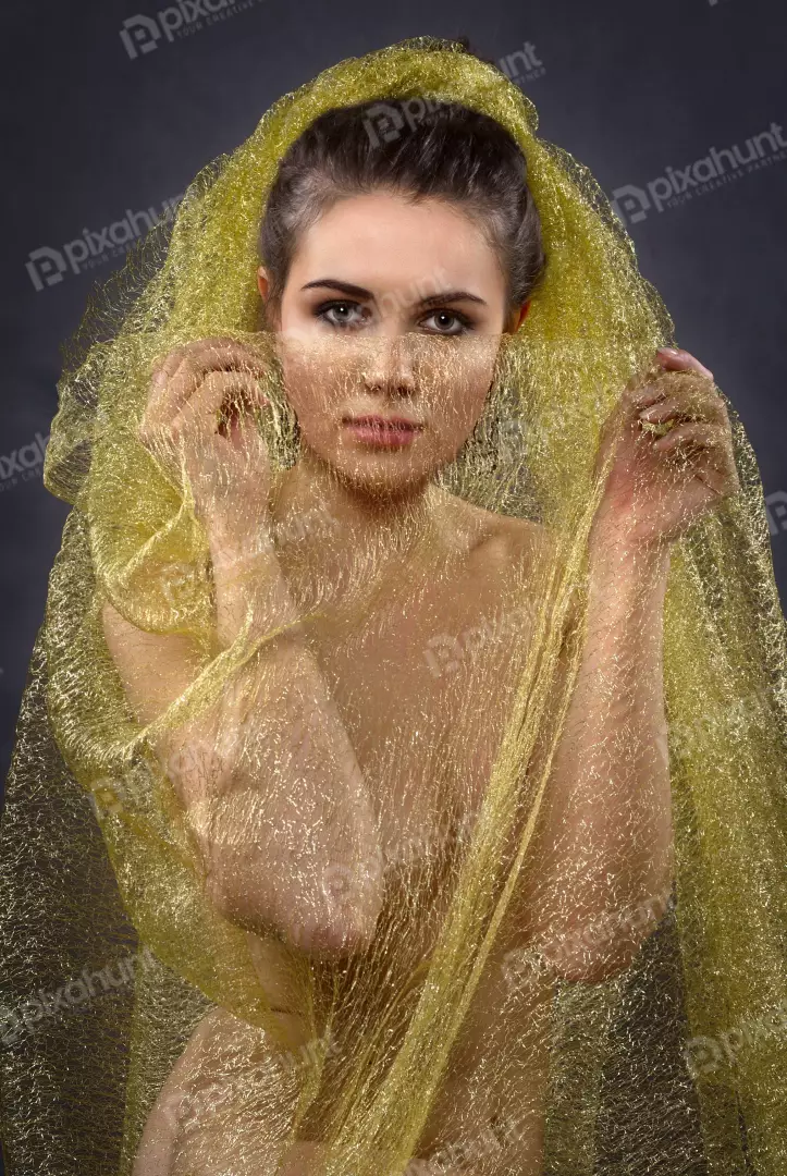 Mysterious Beauty Draped in Glimmering Gold Fabric Portrait