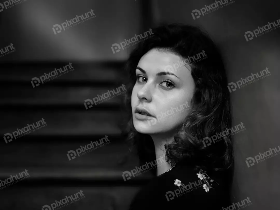 Pensive Young Woman with Intense Gaze in Monochrome Portrait