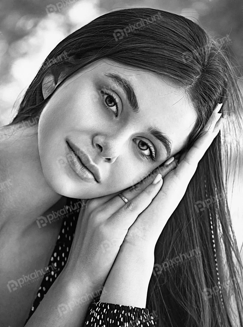 Captivating Black and White Portrait of Young Woman with Long Dark Hair and Clasped Hands