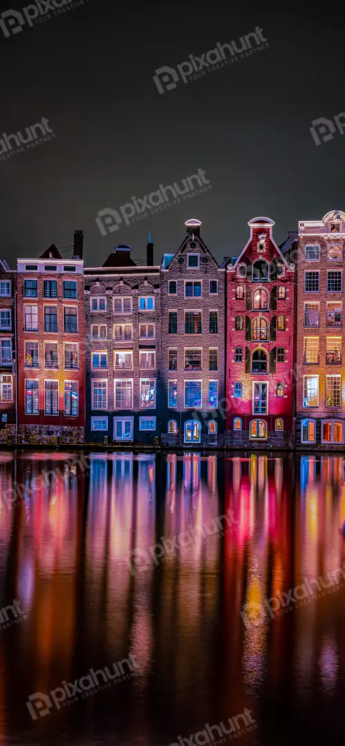 Free Premium Stock Photos Illuminated Amsterdam Canal Houses at Night with Water Reflections