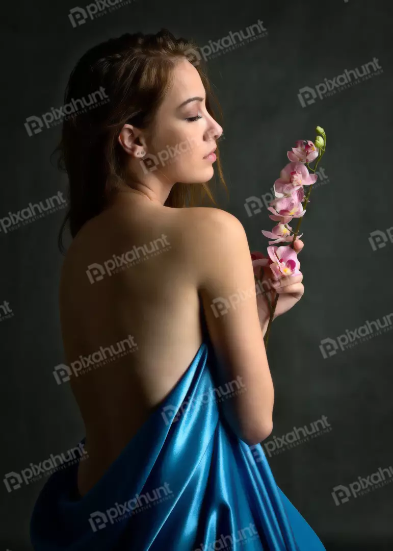 Elegant Woman with Closed Eyes, Blue Satin and Delicate Orchids