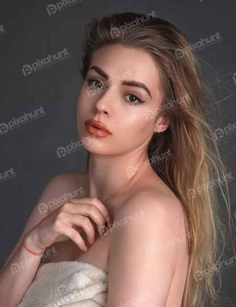 Beautiful Young Woman with Blonde Hair and Elegant Makeup Portrait
