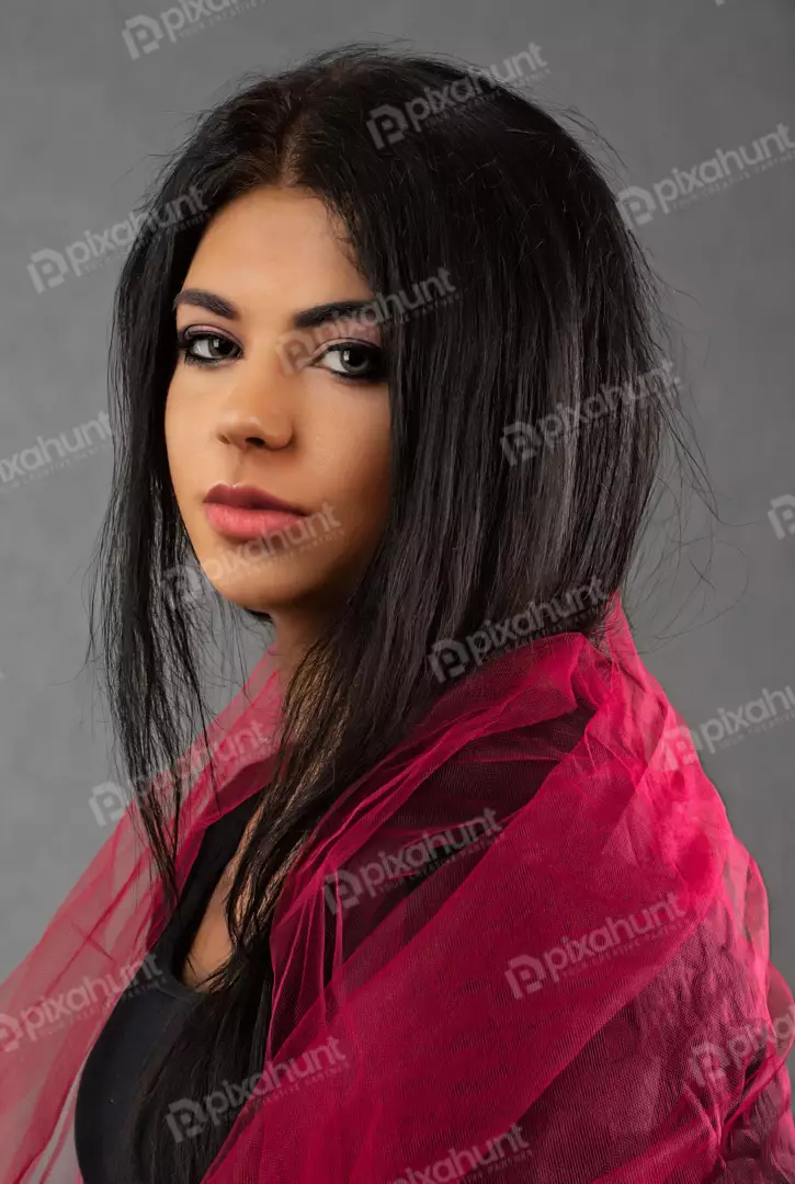 Confident Woman Posing with Long Dark Hair and Vibrant Pink Scarf
