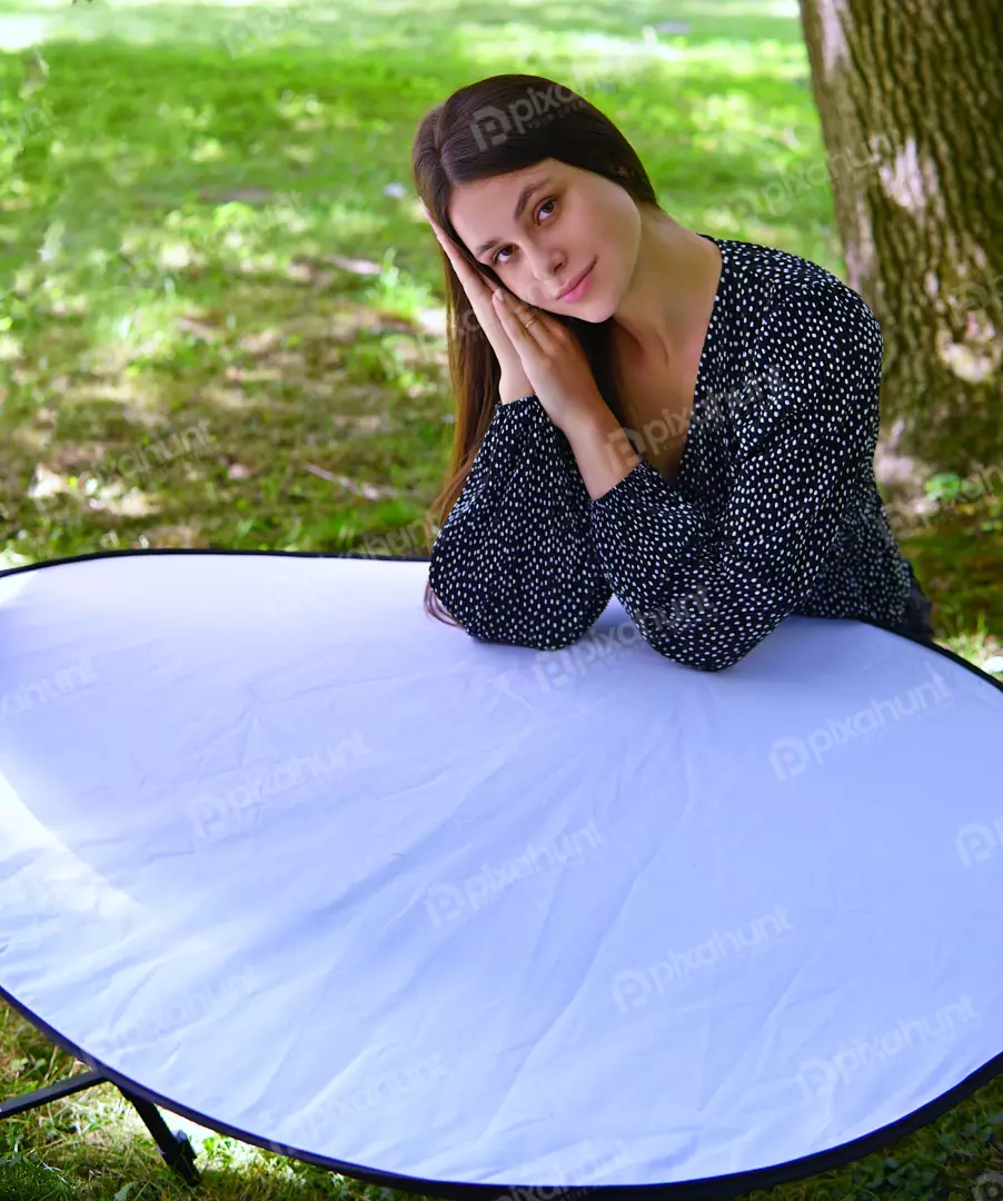 Young Woman Posing with Reflector in Polka Dot Dress Outdoor Portrait