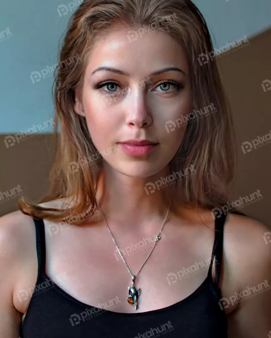 Captivating Young Woman with Blue-Green Eyes and Silver Angel Pendant Portrait