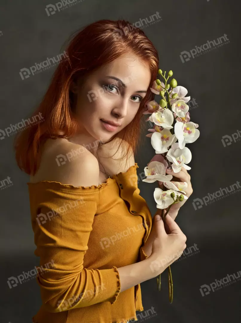 Red-haired Woman Holding White Orchids with Serene Gaze