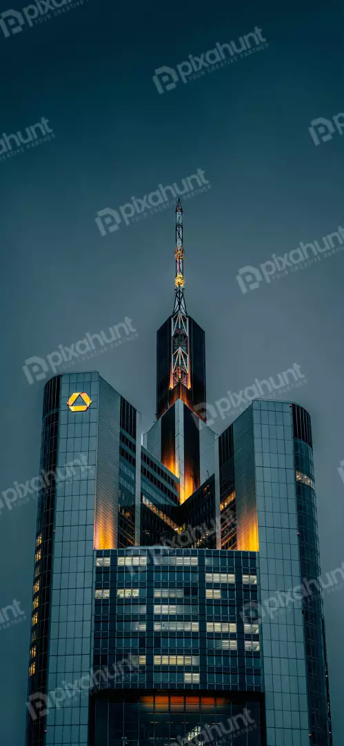 Free Premium Stock Photos Modern Skyscraper Illuminated at Dusk with Iconic Triangle Logo