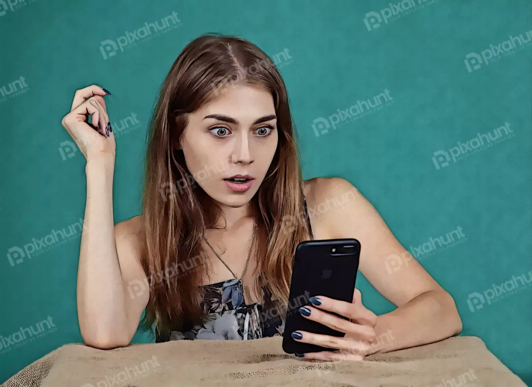 Young Woman Reacting with Shock to Unexpected Smartphone Content