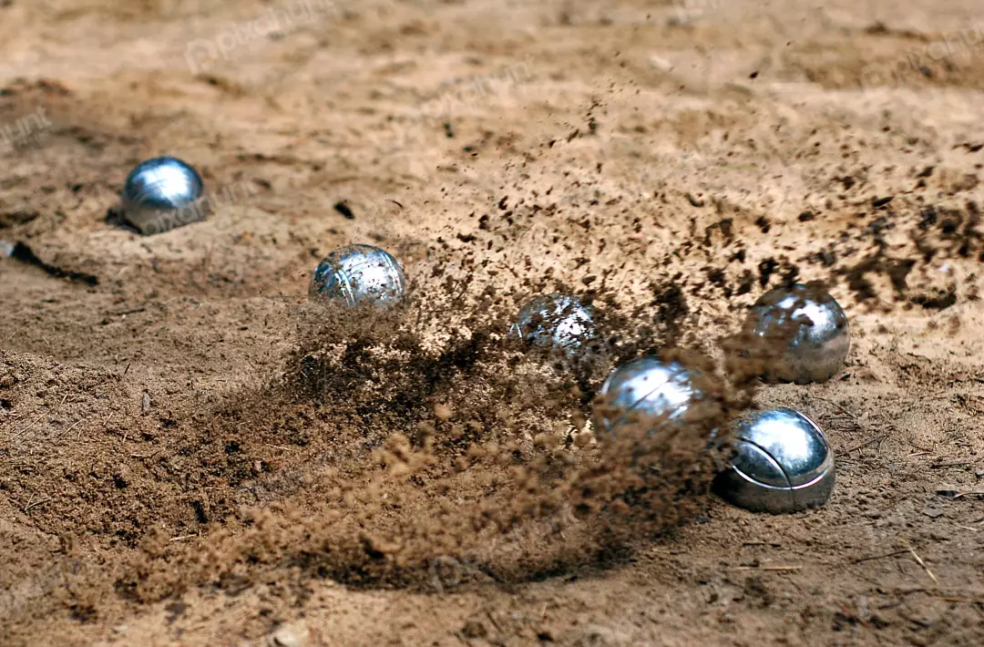 Dynamic Pétanque Boules Striking Sand with Explosive Dust and Action