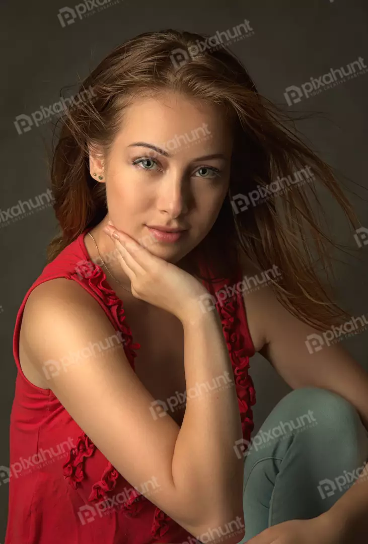 Portrait of a Young Woman with Flowing Hair and Green Eyes Posing Thoughtfully