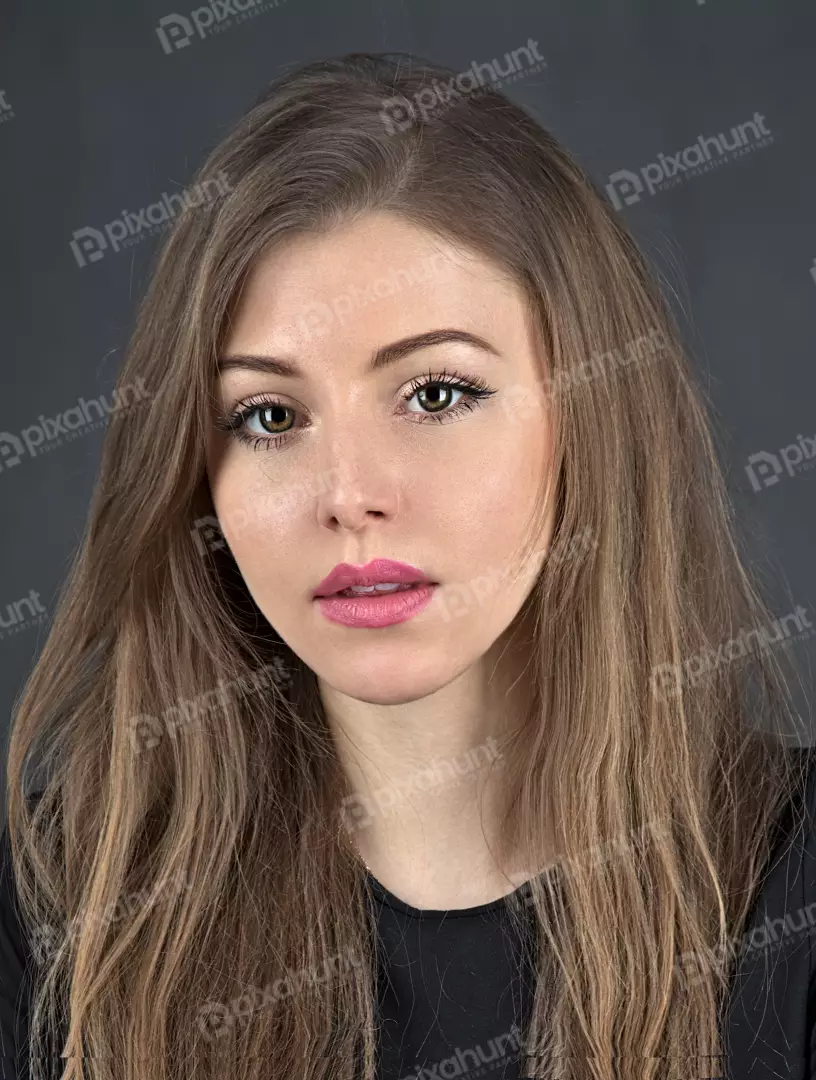 Studio Portrait of Young Woman with Long Wavy Hair and Green Eyes