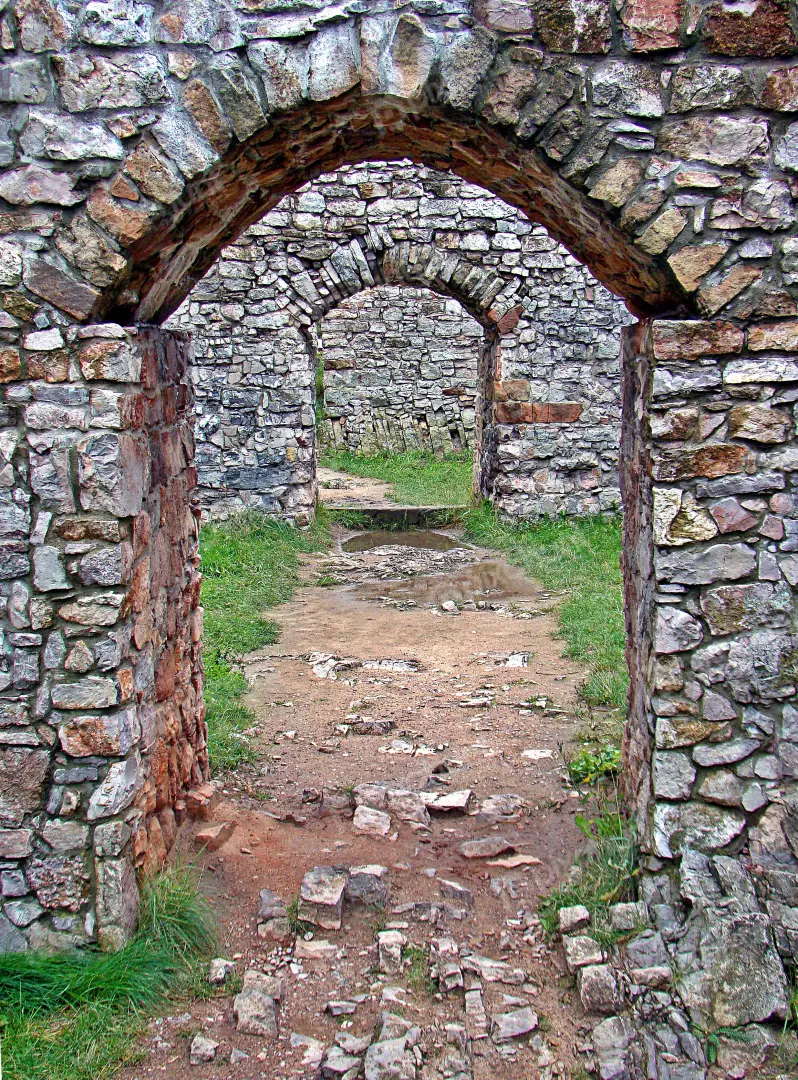 Series of Ancient Stone Archways Leading Through Historic Castle Ruins
