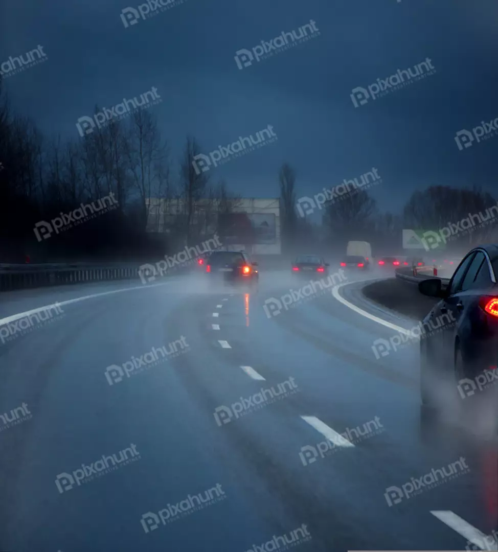 Vehicles Driving on Wet Highway at Night with Heavy Rain and Fog