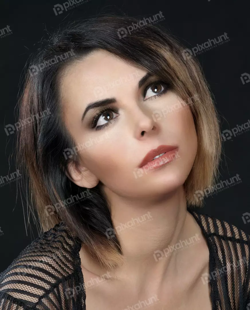 Captivating Woman with Bob Haircut and Expressive Gaze Looking Upwards