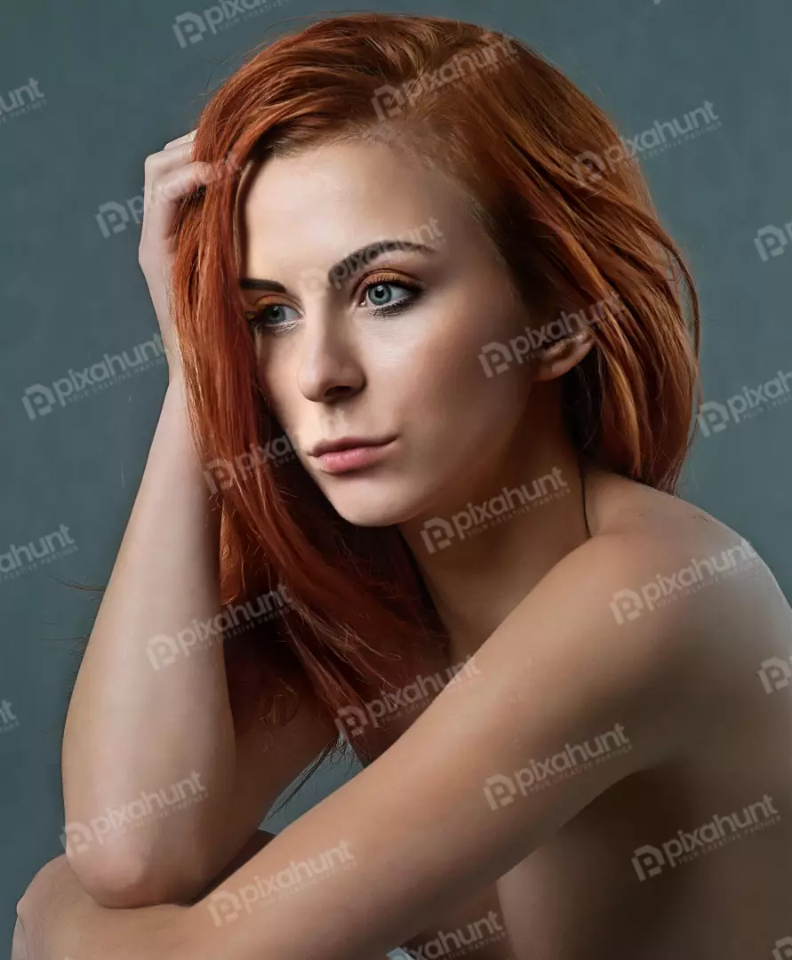 Pensive Young Woman with Vibrant Red Hair and Captivating Blue Eyes