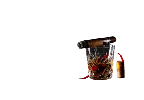 Close up of a brown creamy cocktail glass next to cinnamon sticks